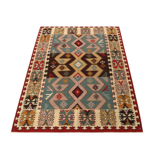Handwoven in Turkey circa 1950-1960, an expressive vintage flatweave rug enjoying nomadic sensibilities entering our Kilim...