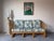 This vintage bamboo and rattan sofa, designed in the style of Ficks Reed, features a classic coastal and tropical...