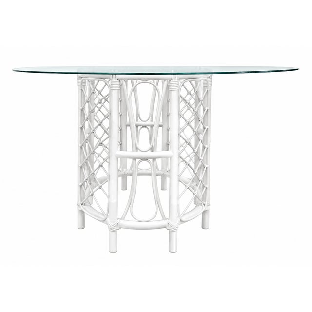 Such a pretty Tortoise finished rattan dining table with a 48" round glass top. Exceptional detail and a perfect old...