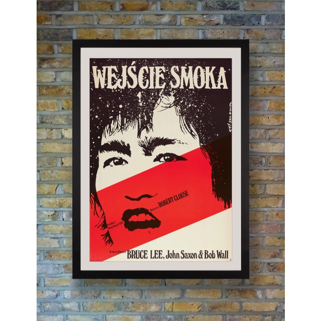 Renowned Polish poster artist Jakub Erol focused on a stark monochrome portrait of Bruce Lee punctuated with a blood red...
