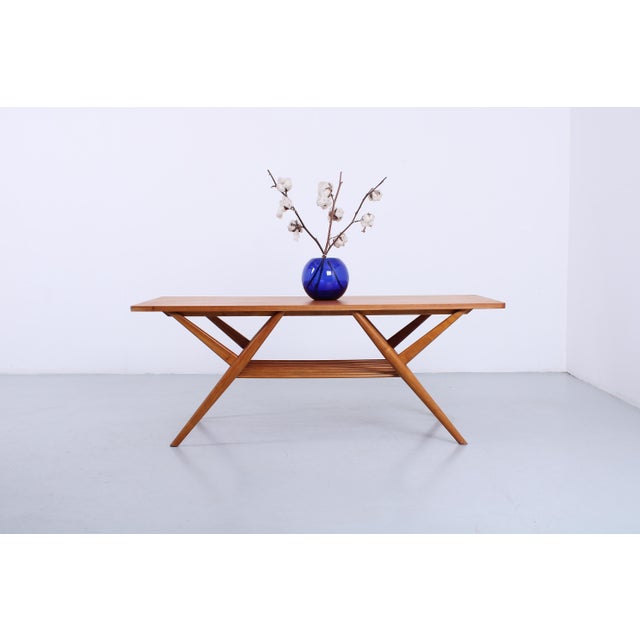 A charming 1950s coffee table with integrated magazine rack. Crafted from a light-toned wood such as alder or beech, this...