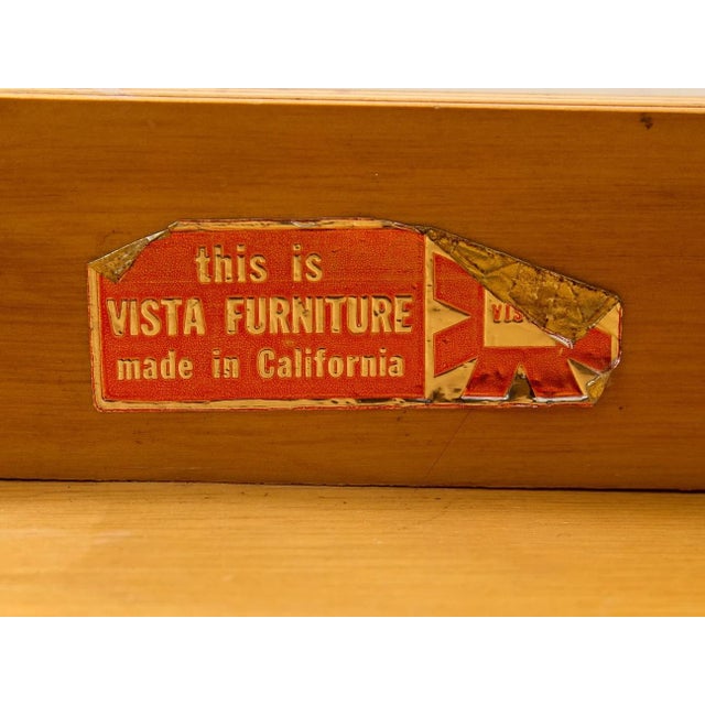 A handsome pair of vintage nightstands combining warm woodgrain surfaces with slim metal legs. Each table features a...
