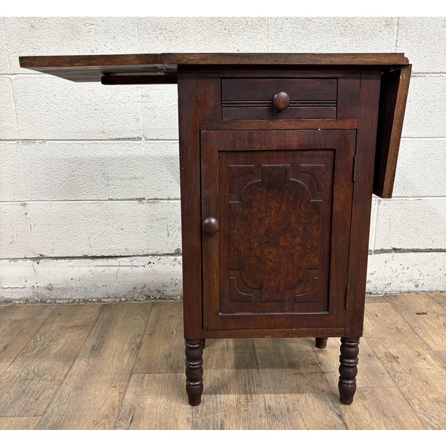 This is an antique, believed to be English Regency, Pembroke drop leaf side table or nightstand. Wood appears to be...