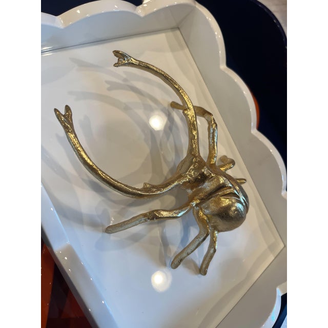 Add a touch of whimsical charm to any vignette with a Wisteria insect in shiny gold finish