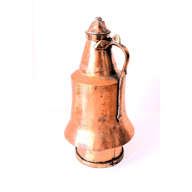 1940's hand hammered copper water Ewer-pitcher. This vessel is a testament to the exquisite craftsmanship of the era. The...