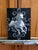 The artwork depicts a majestic white horse in mid-gallop, exuding a sense of dynamism and grace against a stark black...
