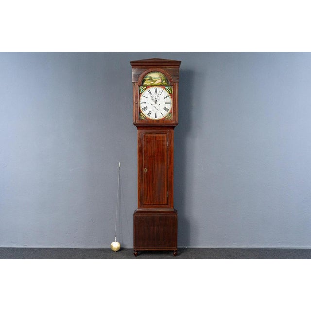 Object: Grandfather Clock Period & Style: England - First half of the 19th century Features: - Elegant, traditional, and...