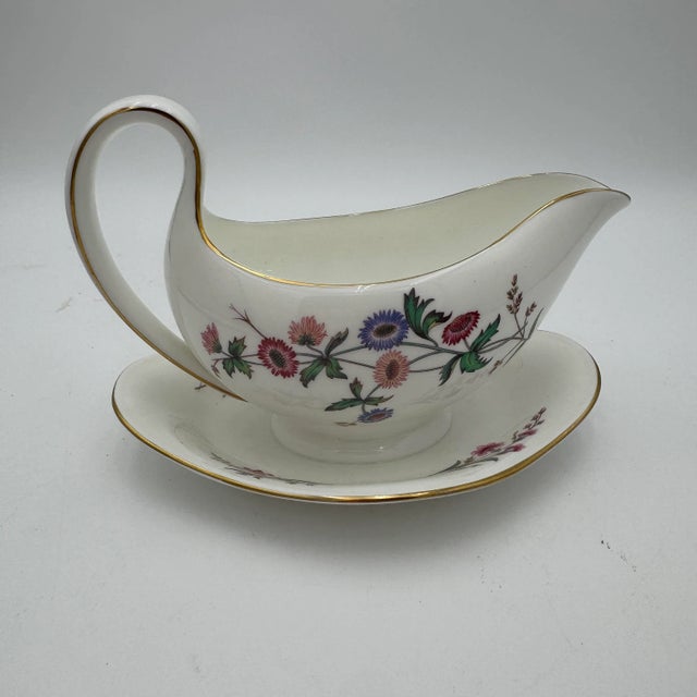 Wedgwoods Devon Sprays is a graceful dinnerware pattern accented with blue & pink flowers, long stems, and leaves. With...