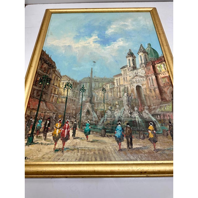 Street scene painted on canvas of Italian plaza. Vintage circa 1960s. Gold wood frame. Signed lower left.