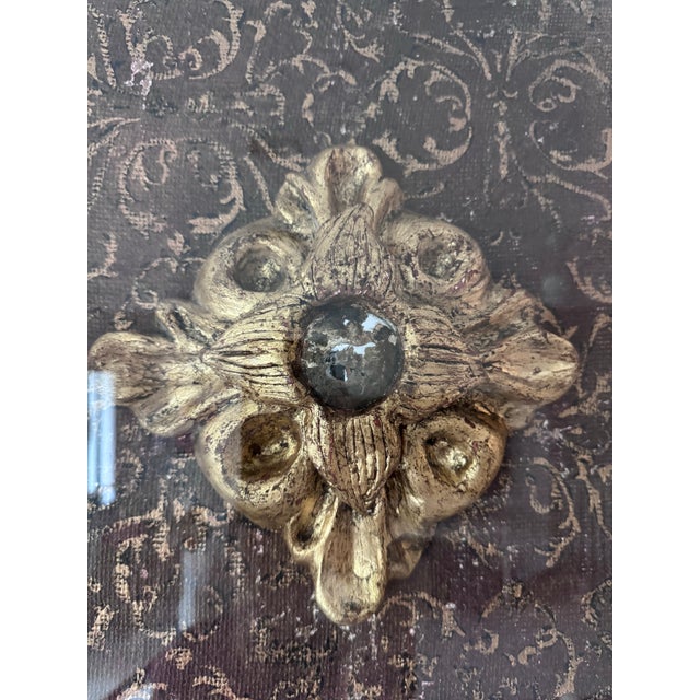 Giltwood and plaster handmade architectural fragment features an antiqued convex mirror. The architectural fragment is...