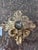 Giltwood and plaster handmade architectural fragment features an antiqued convex mirror. The architectural fragment is...