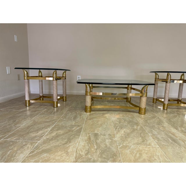 Heavy brass frame with swirl horn shaped legs. Beautiful 3 piece set