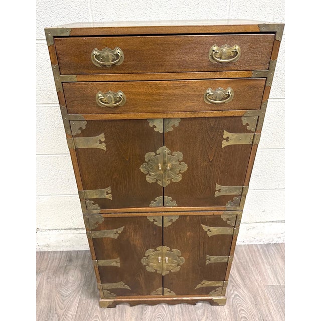 This is a gorgeous vintage Japanese tansu style oak cabinet with striking engraved brass hardware, two drawers, and...
