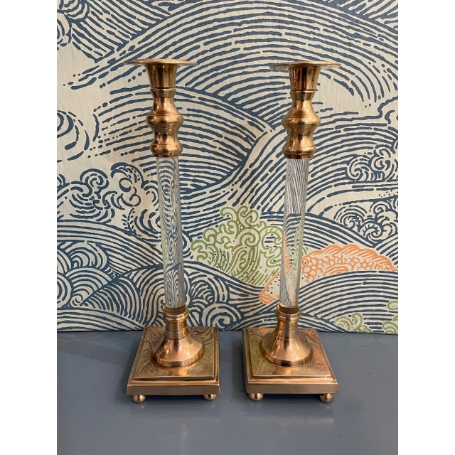 This pair of solid brass and lucite candle holders are unusual in that the base is stepped and sits on 4 ball feet. The...