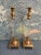 This pair of solid brass and lucite candle holders are unusual in that the base is stepped and sits on 4 ball feet. The...