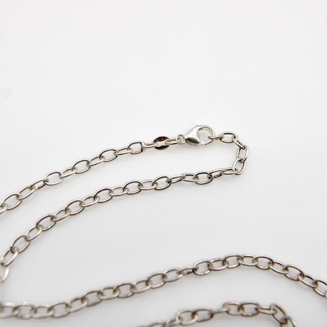 This vintage sterling silver open link chain has a great length and substantial presence on the neck. It consists of open...
