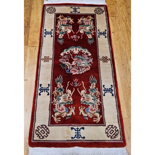 This striking vintage Chinese area rug from the third quarter of the 20th century reflects the bold aesthetic and symbolic...