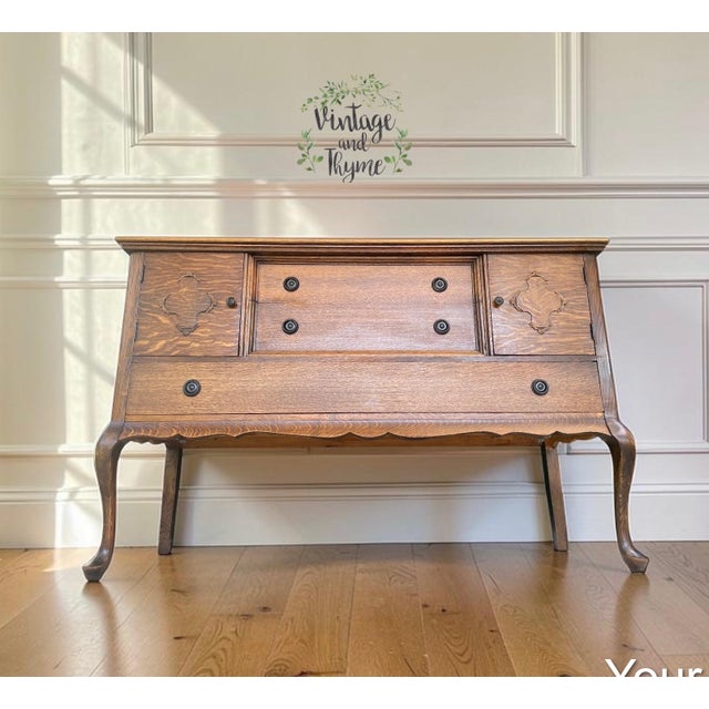 This Queen Anne Tiger Oak Buffet is in excellent condition. The top has been sanded and sealed with polyurethane. The...
