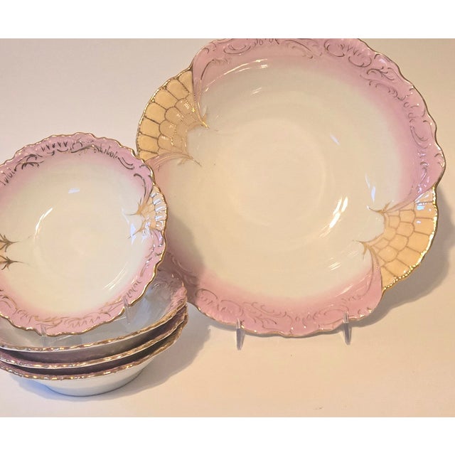 Iridescent pink and champagne bowls are covered in flounce and gold. The intricate design reminds me of 1860s ball gowns....