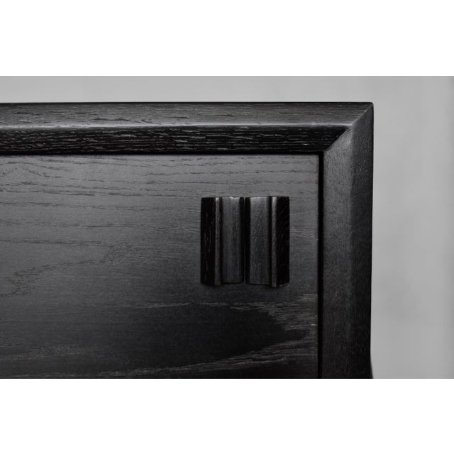 This modernist sideboard was made in Scandinavia during the 1960s. It was made of oak wood, which is considered royal...