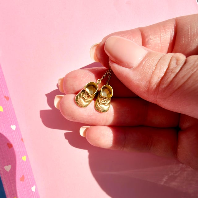 About This Charm: Few things feel quite as sentimental as a tiny pair of baby shoes. Dating to approximately the 1960s,...