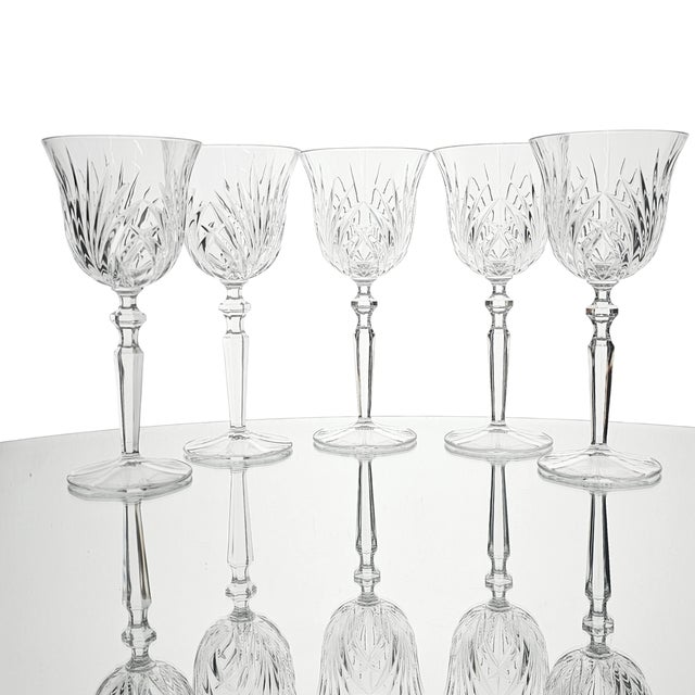In the clear light, these goblets rise slender and sure, their bowls etched in crisp geometry that catches every glint of...