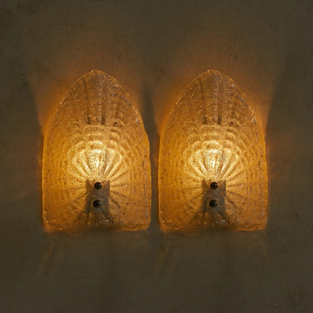 A pair of Swedish 'Model 6310' wall sconces designed by Globen AB in the 1960s. Each features a thick, sculptural pressed-...