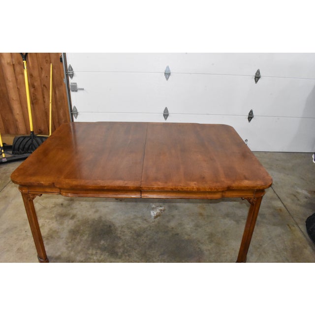 Elegant Regency style dining table made of walnut with burl wood banding. Banding has a distressed look. Comes with 2...