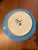This is a hand-painted 11-inch ceramic plate by artist Denise Ford from 1990 featuring a striking Arabian desert motif...