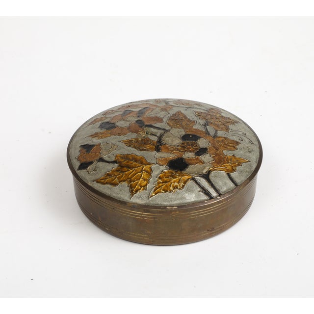 Vintage cloisonné round trinket box, with black and gold flower and foliage decorating the lid. Made in India sticker on...