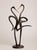 A contemporary animal bronze of two storks, their long necks curving toward one another so the negative space between them...
