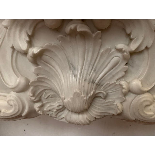 Louis xv style fireplace in white carrara marble, italy two curved jambs with scrollwork, carved with leaves and shells...