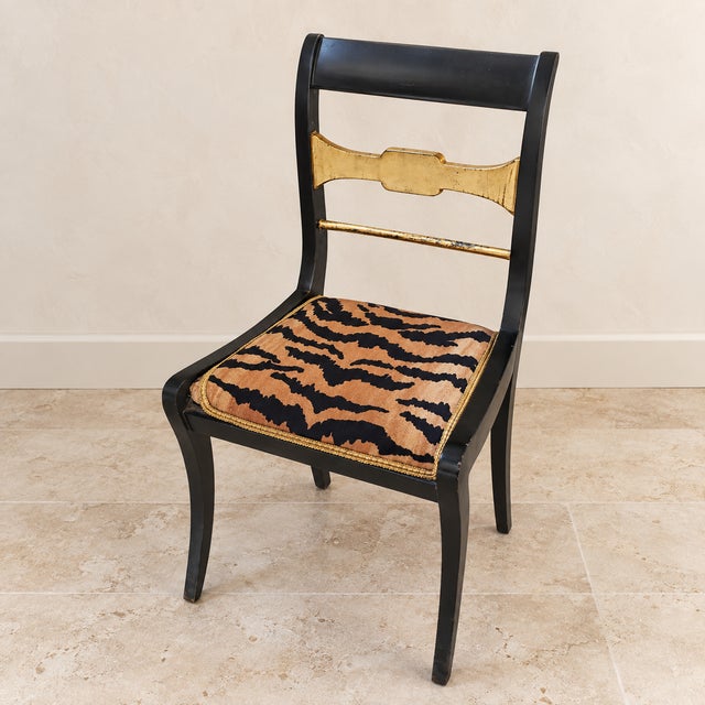 Add a dramatic touch of European elegance with this distinctive black neoclassical accent chair, featuring a sleek black...