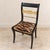 Add a dramatic touch of European elegance with this distinctive black neoclassical accent chair, featuring a sleek black...