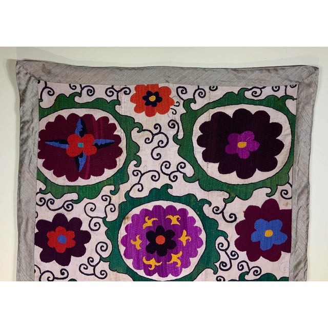 Antique Suzani textile fragment made of hand embroidery intricate scrolling of eight large flowers motifs on a handwoven...