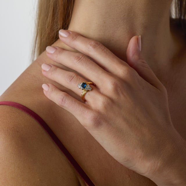This vintage sapphire and diamond ring is a beautifully refined jewel from the 1970’s, crafted in warm 18k yellow gold...