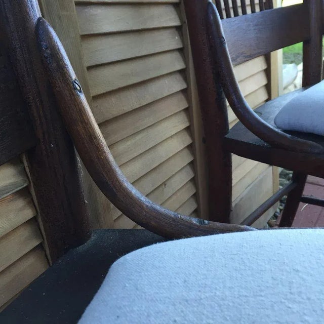 Beautiful detail with original finish, wood turned spindles, hip rests and newly upholstered light beige drop cloth seats...