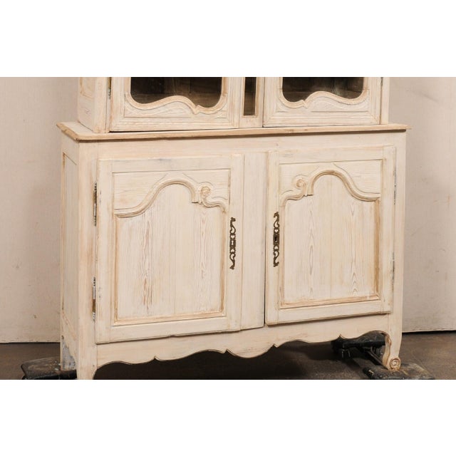 A French Louis XV style carved and painted wood buffet à deux-corps display and storage cabinet from the early 19th...