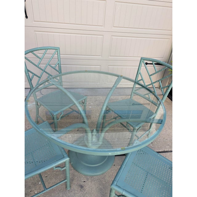 Offered is a five piece patio dining set by Meadowcraft. This set features a faux bamboo style frame with removable glass...