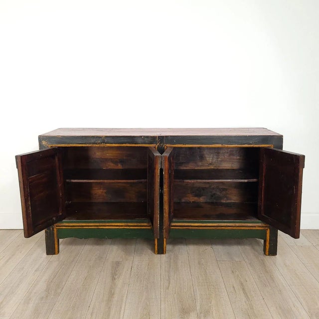 A Tibetan or Mongolian painted four-door cabinet, 19th century with substantially original paint.