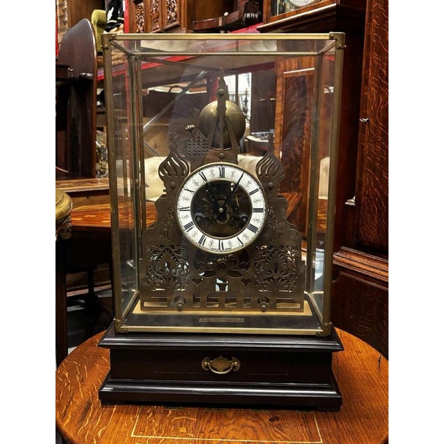 Large Brass Architectural Cathedral Skeleton Clock with Case And Key. Chimes. Drawer in base for winding key. Ticking away...