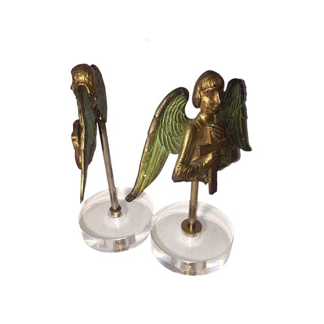 Pair of bronze doré Byzantine style angels with original green color over bronze on the wings. Mounted on lucite stands.