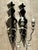 Exuding Hollywood Regency glamour and vintage sophistication, this pair of wall sconces features scalloped mirrored...