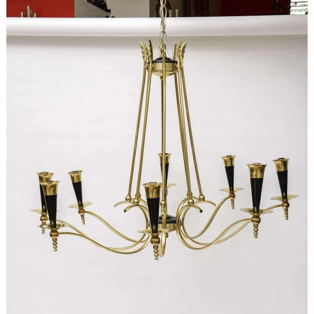 Offered is an Italian chandelier in a gorgeous metallic brass finish with black accents. This beauty features eight socket...