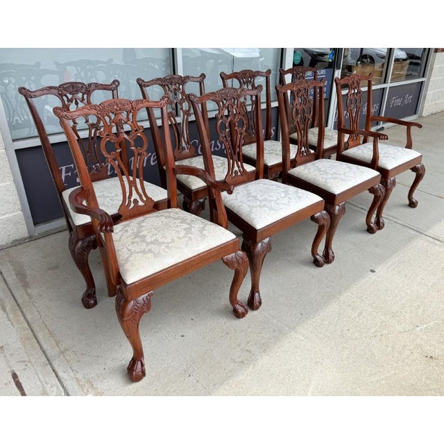 This set of eight Hickory Chair dining chairs features classic Chippendale-inspired styling with pierced carved splat...