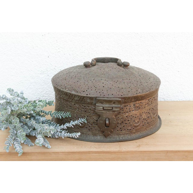 This piece is a tactile treasure map. Every inch of the surface is covered in hand-chased geometric and floral engravings....