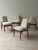 Set of four dining chairs imported from Italy, dating to approximately the late 1950s–1960s. The sculpted wood frames...
