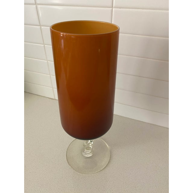 Elegant cylindrical vase with a deep caramel cased glass top with a clear foot. This hand blown work would look amazing as...