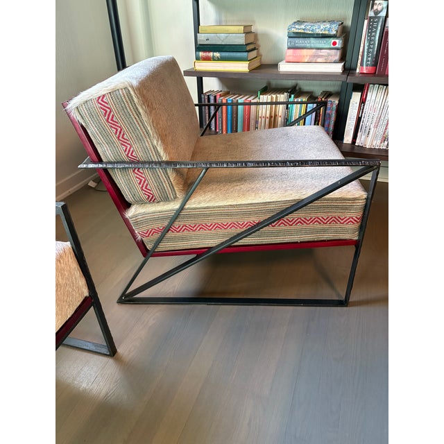 Custom designer accent chairs, book-matched hair on hide chairs. Backs and sides of cushions in upholstery fabric Ralph...