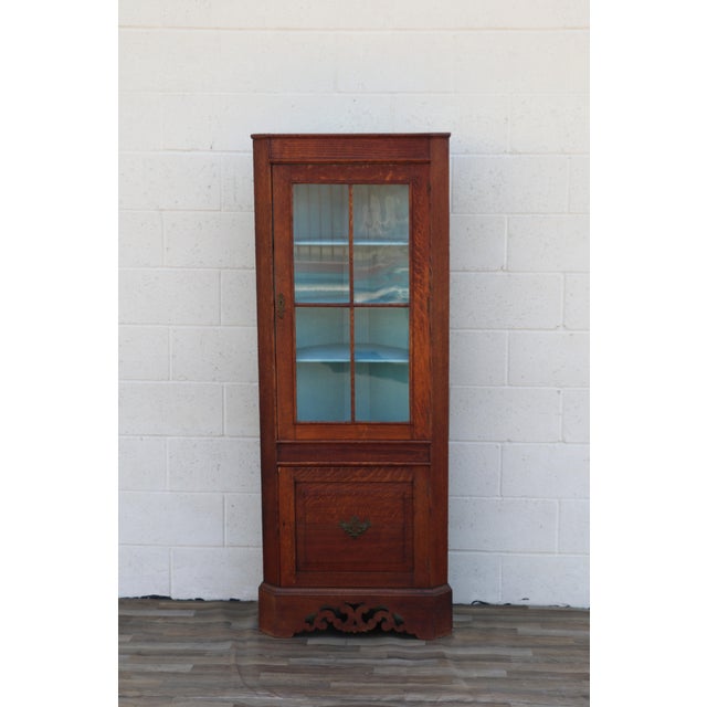 Beautiful antique English oak corner cabinet or cupboard dating to circa 1920s, manufactured by Walter Skull & Son, Ltd.,...
